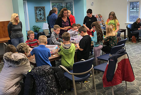 2018 Lego night event, kids working on a table with adults assisting